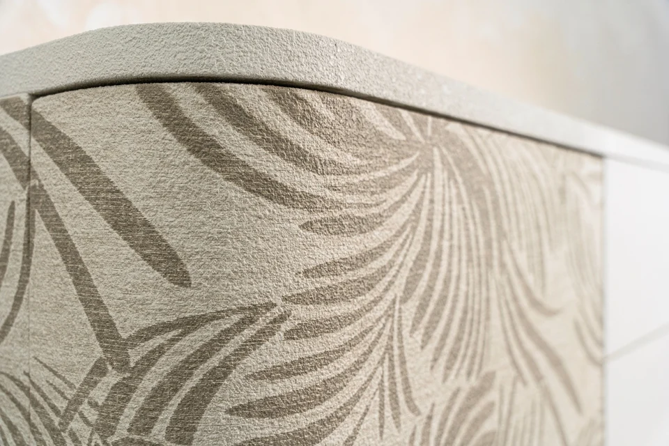 Curved furniture detail with a natural Woodress finish and botanical decoration
