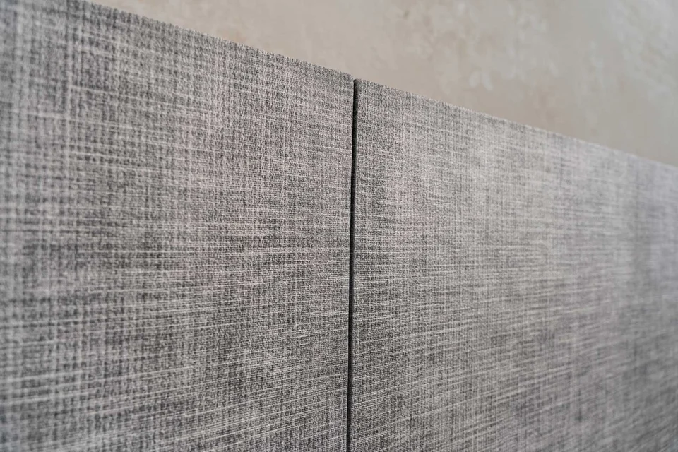 Detail of cabinet doors with a grey textile-inspired Woodress finish